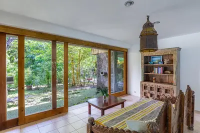 a living room with a large window and a table at Villa Carlotta in Respingue