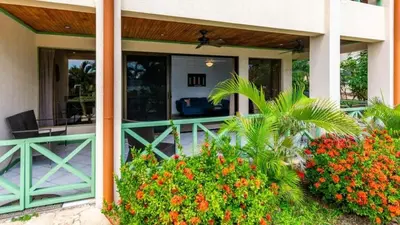 a porch of a house with flowers and plants at Elegant Condo with Brand-New Fixtures, Shaded Tropical Terrace, and Secluded Beach Access in Playa Flamingo