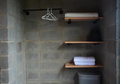 a bathroom with shelves and towels on a wall at Espectacular Cabaña Moderna de Montaña + Bosque Nuboso +Wifi in Zarcero