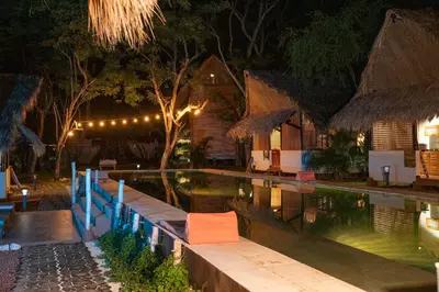 a resort with a swimming pool at night at LA QUEBRADA ECO LODGE Hotel Boutique in Potrero
