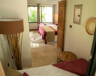 a bedroom with two beds and a window at LA QUEBRADA ECO LODGE Hotel Boutique in Potrero