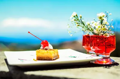 a piece of cake on a plate next to a drink at Hotel Montaña Monteverde in Monteverde Costa Rica