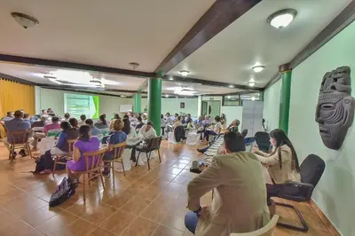 a group of people sitting in chairs in a room at Hotel Montaña Monteverde in Monteverde Costa Rica
