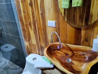a wooden sink in a bathroom with a toilet at Onca Tours & Treehouses in San Rafael