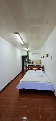 a bedroom with a large bed in a room at Sleep&Go! Cabinas en Siquirres Centro - Rafting tour - Tarifa corporativa Disponible in Siquirres