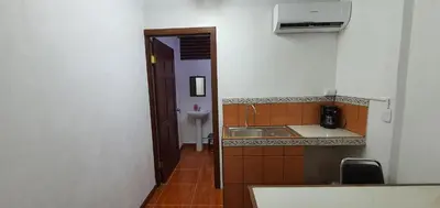 a small kitchen with a sink and a microwave at Sleep&Go! Cabinas en Siquirres Centro - Rafting tour - Tarifa corporativa Disponible in Siquirres