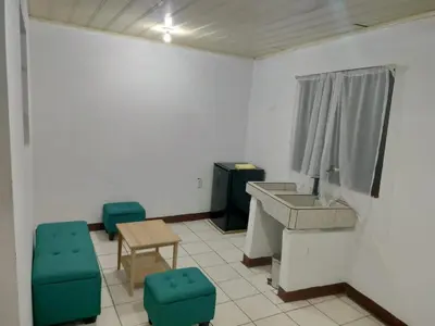 a room with a sink and a table and chairs at Departamentos Patricia in Alajuela City