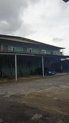 a building with a car parked in front of it at Departamentos Patricia in Alajuela City
