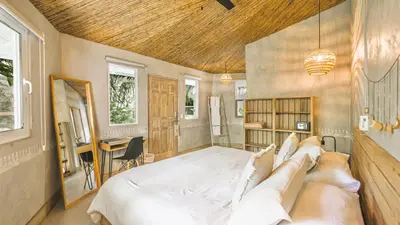 a bedroom with a large bed and a desk at Norte Nosara - Steps to Playa Guiones in Nosara