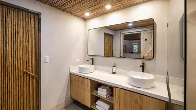a bathroom with two sinks and a mirror at Norte Nosara - Steps to Playa Guiones in Nosara