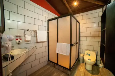 a bathroom with a toilet and a sink at Villas Paradise Arenal Volcano Lake View in El Castillo de La Fortuna