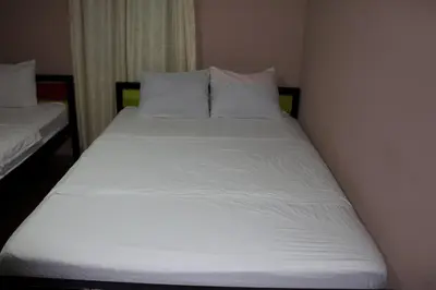 a bed with white sheets and pillows in a room at Hotel La Castella in San José