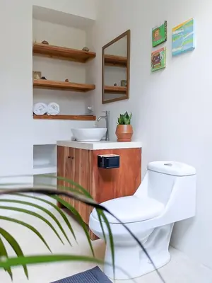 a bathroom with a toilet and a sink at El Hábita CASA MAR in Santa Teresa Beach