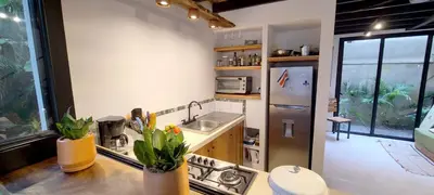 a kitchen with a sink and a counter top at El Hábita CASA MAR in Santa Teresa Beach
