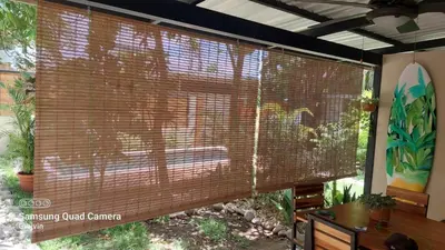 a large window with a wooden blind in a room at El Hábita CASA SELVA in Santa Teresa Beach