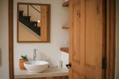 a bathroom with a white sink and a mirror at El Hábita CASA SELVA in Santa Teresa Beach