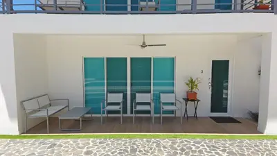 a group of chairs and tables on a patio at Nicoya Villas in Mal País