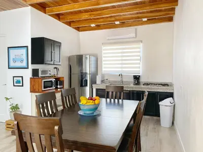 a kitchen with a wooden table with a bowl of fruit on it at Nicoya Villas in Mal País