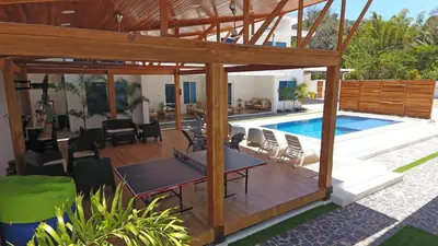 a villa with a swimming pool and a patio at Nicoya Villas in Mal País