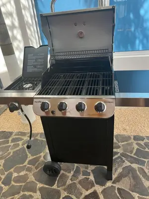 a barbecue grill with a laptop on a table at Nicoya Villas in Mal País