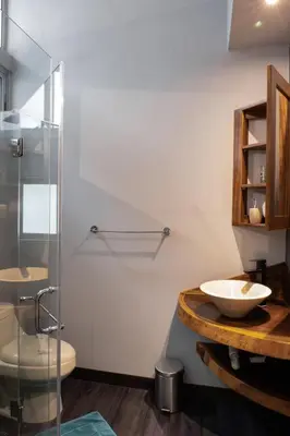 a bathroom with a sink and a glass shower at Hotel FAREMITI Uvita in Uvita