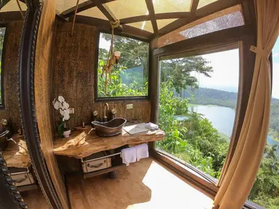 a bathroom with a sink and a large window at Casa maar -Treetop tent in Río Cuarto