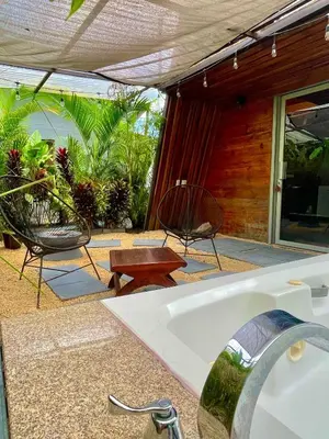 a kitchen with a sink and chairs on a patio at Tiny Villa Experience in Fortuna