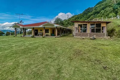 a house with a grass field in front of it at Casita El Sastre in Paso Macho