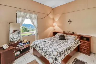 a bedroom with a bed and a mirror at Casita El Sastre in Paso Macho