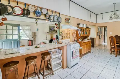 a kitchen with a counter and stools in it at Casita El Sastre in Paso Macho