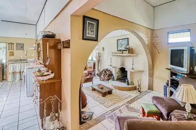 a living room with an archway and a fireplace at Casita El Sastre in Paso Macho
