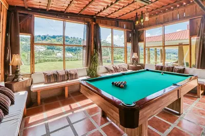 a pool table in a room with windows at Casita El Sastre in Paso Macho
