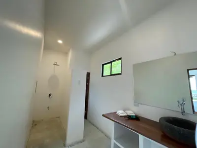 a bathroom with a sink and a mirror at Akua Suites Ocean View in Tarcoles