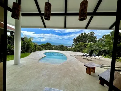 a view of a swimming pool from a house at Akua Suites Ocean View in Tarcoles