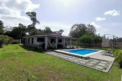 a house with a swimming pool in a yard at Villa Tropical La Fortuna in Fortuna