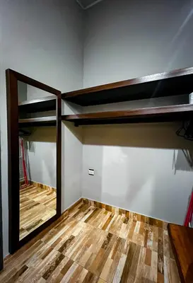 a room with two bunk beds and a wooden floor at Casita Anastacia in Uvita