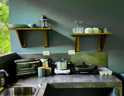 a kitchen counter with a sink and a stove at Casita Anastacia in Uvita