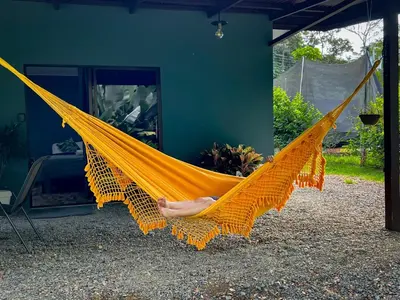 a person laying in a yellow hammock at Casita Anastacia in Uvita