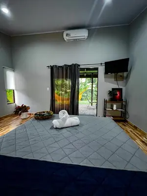 a bedroom with a large bed with a towel on it at Casita Anastacia in Uvita