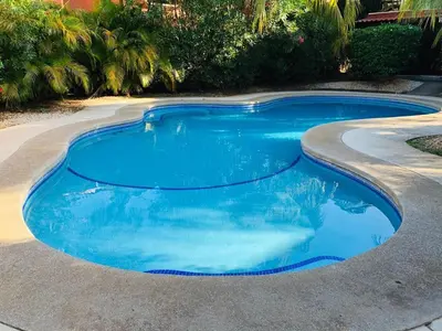 a swimming pool with blue water in a driveway at Valle Dorado 9 in Coco