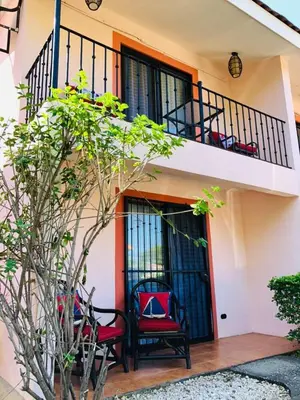 a building with two chairs sitting on a balcony at Valle Dorado 9 in Coco