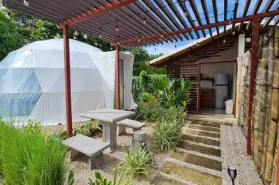 a backyard with a tent and a bench and a table at Ubuntu Glamping in Guanacaste