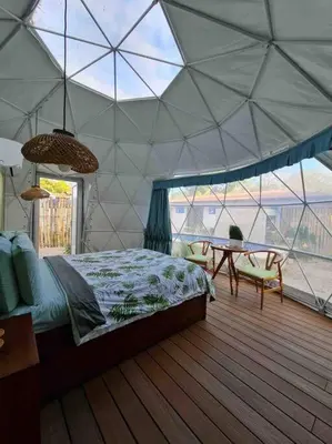 a bedroom with a tent with a bed and a table at Ubuntu Glamping in Guanacaste