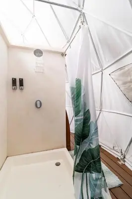 a room with a tent with a plant in it at Ubuntu Glamping in Guanacaste