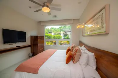 a bedroom with a large bed with a window at Montecielo 3E 3bdrs ocean view in Los Suenos in Herradura