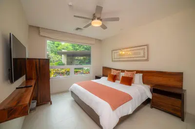a bedroom with a large bed and a window at Montecielo 3E 3bdrs ocean view in Los Suenos in Herradura