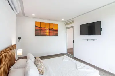 a living room with a couch and a flat screen tv at Luxury Villa #11 El Oceano in Playa Hermosa
