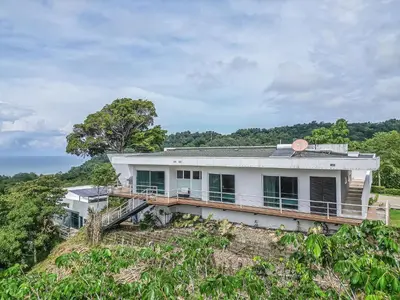 a white house on top of a hill at Luxury Villa #12 Las Flores in Playa Hermosa