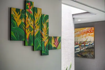 a group of paintings hanging on a wall at Luxury Villa #12 Las Flores in Playa Hermosa
