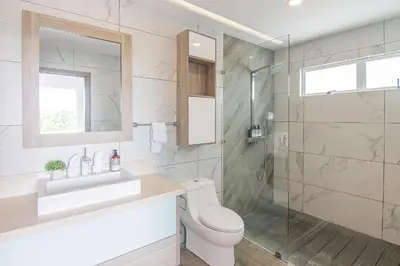 a bathroom with a toilet and a sink and a shower at Luxury Villa #12 Las Flores in Playa Hermosa